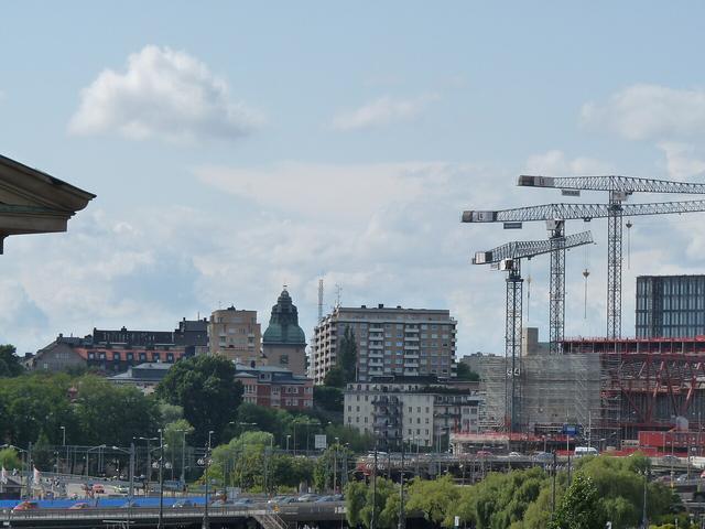 Stockholm waterfront with cranes over new buildings